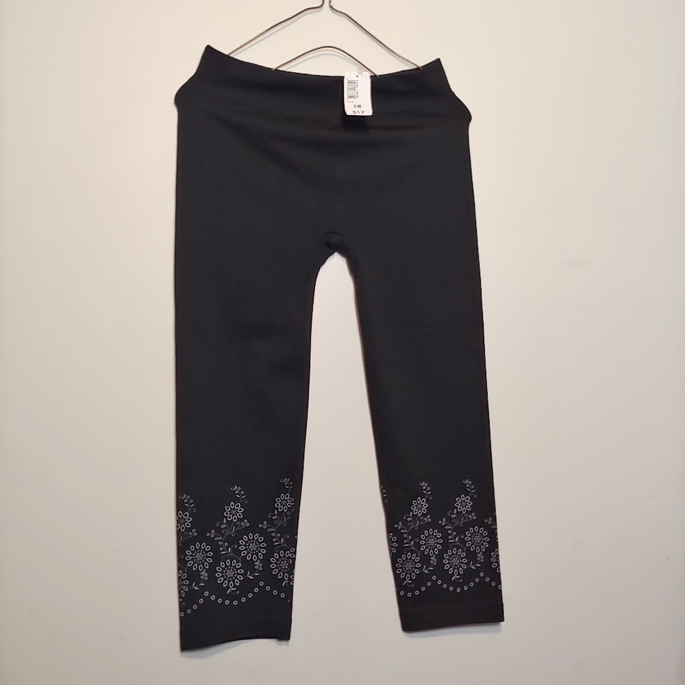 Black capris with white flowers at the bottom